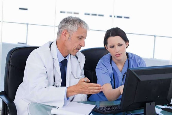 Professional medical team working with a computer in an office