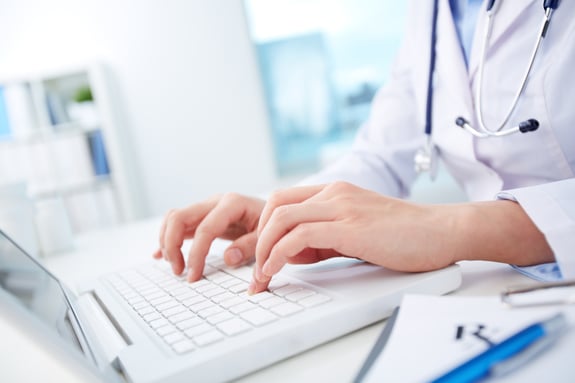 healthcare worker on laptop