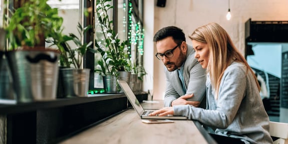 two people using laptop